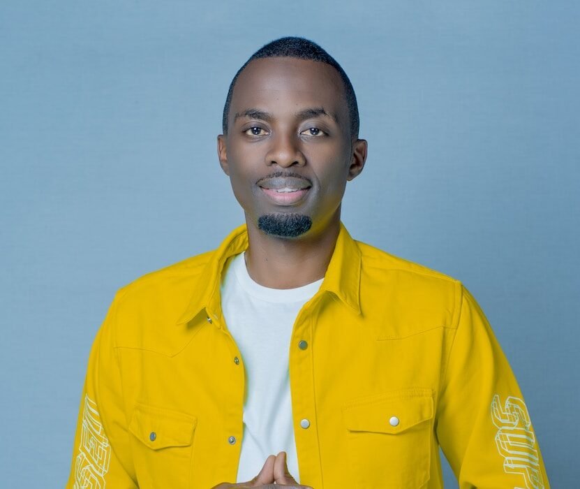 a man in a yellow shirt posing for a picture